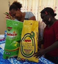 Sabina Pelomo from the Solomon Islands biosecurity staff and Minnie Vaike from customs examine bags of fortified rice.